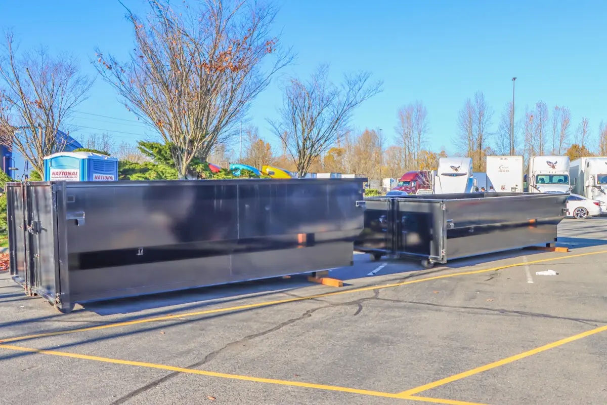 Professional dumpster rental service with roll-off container on residential driveway in Verde Village